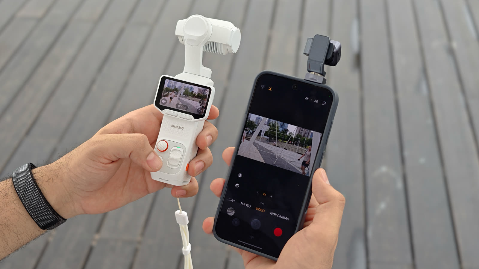 HONOR Robot Phone held beside an Insta360 Luna Ultra pocket gimbal camera during a comparison